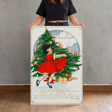 It’s More than Merry Christmas — Girl beside a Christmas Tree canvas print, canvas shown with a person for scale