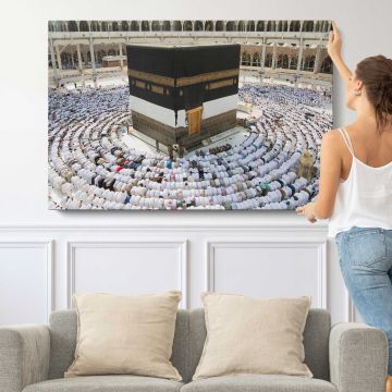 Kaaba Surrounded by Pilgrims - single-panel canvas shown with a person for scale