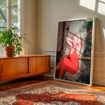 Glamorous black and white star Marilyn Monroe is seen here in full color wearing a red halter jumpsuit seated in nature in a joyful pose ideal for vintage fashion lovers and collectors of iconic actress artwork that brings Hollywood history into home deco