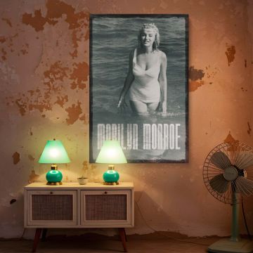 Beautiful vintage photograph of Marilyn Monroe in ocean water wearing a white retro swimsuit her smile reflecting warmth and timeless style a must-have for anyone decorating with inspirational Hollywood art and black and white photography prints.