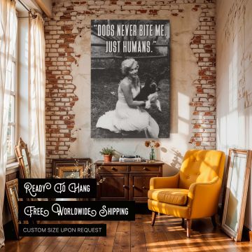 Black and white celebrity quote art featuring Marilyn Monroe laughing with a dog in her lap accompanied by her famous dogs never bite me just humans text perfect for classic movie collectors dog enthusiasts and lovers of humorous empowering vintage decor.