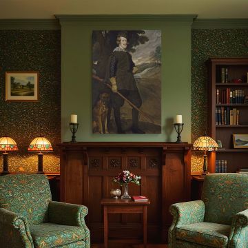 Regal canvas wall art reproduction of Velazquez's King Philip IV as a Huntsman capturing the Spanish king in hunting garb with a musket, posed with relaxed dignity and grace against a forest backdrop, perfect for classical and traditional interior design.