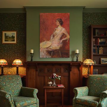 A masterful depiction of feminine grace captured in this canvas wall print of "The Palm Leaf Fan" by Thomas Wilmer Dewing. The seated woman appears calm and self-assured in a delicate pink gown, framed by a richly painted red background. The use of tonal 