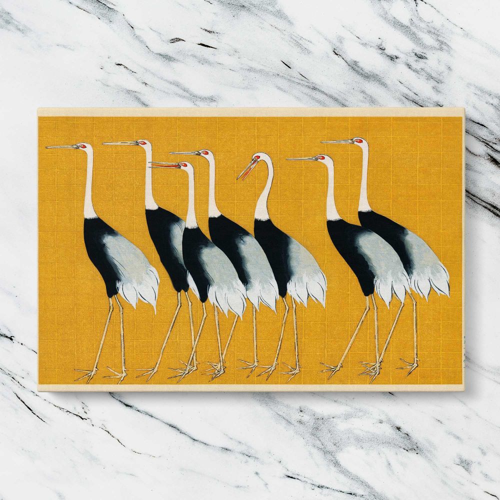 Japanese Cranes on Gold canvas artwork displayed on a marble background