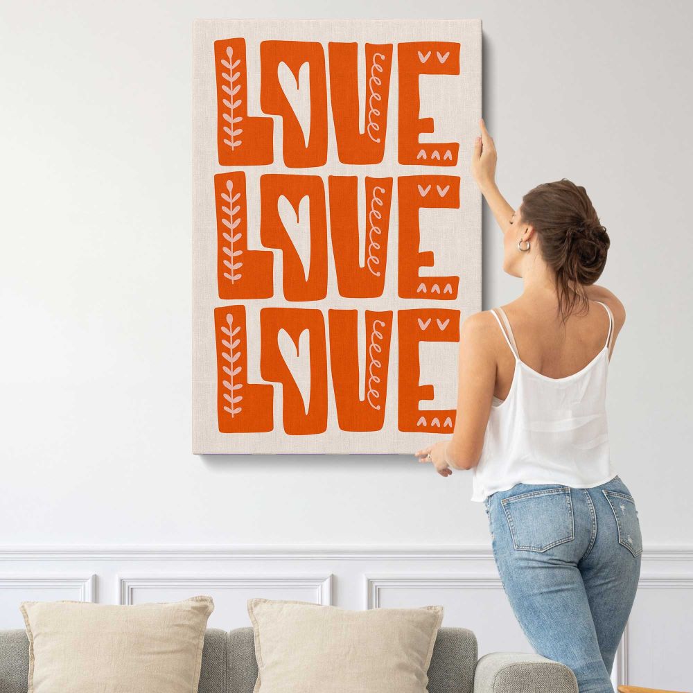 Love Love Love Orange Typography canvas print, displayed on a wall