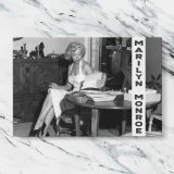 Marilyn Monroe Seated at a Table canvas artwork displayed on a marble background