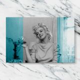 Marilyn Monroe Smiling Turquoise Portrait canvas artwork displayed on a marble background