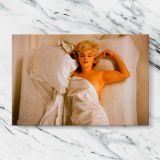 Marilyn Monroe Resting in Bed canvas artwork displayed on a marble background