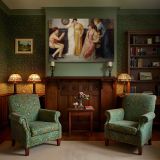 A Youth Relating Tales to Ladies canvas wall art in room setting 7