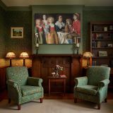 Family Gathered around a Table canvas wall art in room setting 7