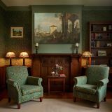 Classical Ruins overlooking a Coastal Town canvas wall art in room setting 7