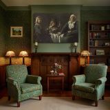 Women and a Child at a Simple Table canvas wall art in room setting 7