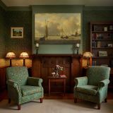 Boats beneath a Golden Clouded Sky canvas wall art in room setting 7