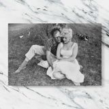 Marilyn Monroe and Arthur Miller Outdoors canvas artwork displayed on a marble background