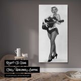 Marilyn Monroe Playing Guitar canvas wall art displayed in a contemporary room