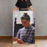 Girl Sewing beside a Window canvas print, held for scale