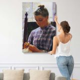 Girl Sewing beside a Window canvas print, displayed on a wall