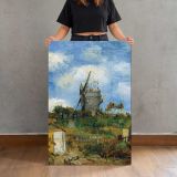 Windmill beneath a Blue Sky by Vincent Van Gogh canvas print, held for scale
