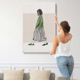 Woman Walking in a Green Jumper canvas print, displayed on a wall