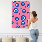 Blue Evil Eye Pattern on Pink canvas print, displayed on a wall