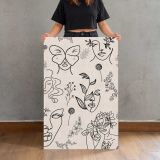 Botanical Faces and Butterflies Line Art canvas print, held for scale