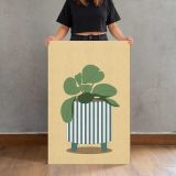 Green Houseplant in a Striped Pot canvas print, held for scale