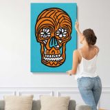 Orange Sugar Skull on Turquoise canvas print, displayed on a wall