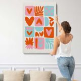 Orange Pink and Turquoise Heart Collage canvas print, displayed on a wall