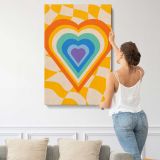 Rainbow Heart on Yellow Checkerboard canvas print, displayed on a wall