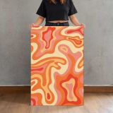 Orange and Cream Psychedelic Swirls canvas print, held for scale