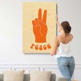Orange Peace Hand on Yellow canvas print, displayed on a wall
