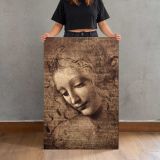 La Scapigliata by Leonardo da Vinci canvas print, held for scale