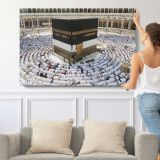Kaaba Surrounded by Pilgrims - single-panel canvas shown with a person for scale