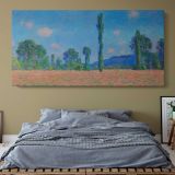 Poppy Field at Giverny by Claude Monet — single-panel canvas above a bed with blue bedding