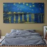 Starry Night Over the Rhone by Vincent van Gogh — single-panel canvas above a bed with blue bedding