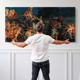 The Triumph of the Innocents by William Holman Hunt — single-panel canvas shown behind a standing person for scale