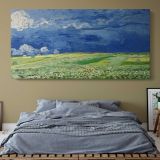 Wheatfield under Thunderclouds by Vincent van Gogh — single-panel canvas above a bed with blue bedding